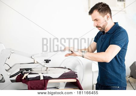 Man Printing Shirt In A Workshop