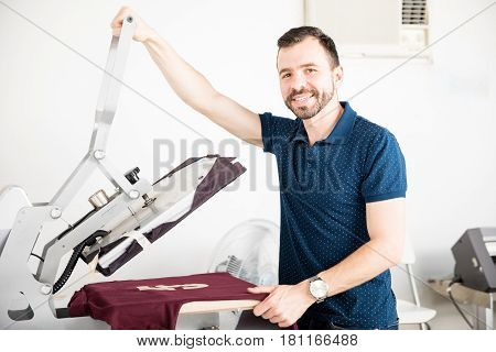 Handsome Worker Using A Serigraph Press