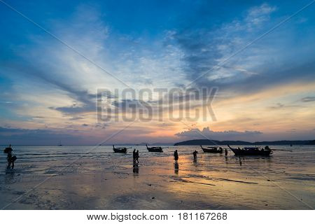 People on the Ao Nang beach at sunset in Krabi province Thailand