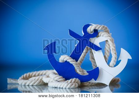 Wooden decorative anchor on the blue background