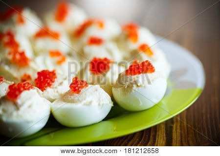 Eggs stuffed red caviar on a plate