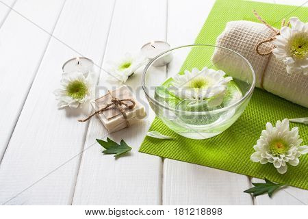 Chamomile And Candle Spa On A White Wooden Background