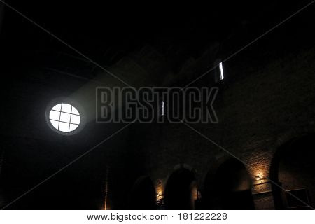 Interior of an old church and the light that filters through the rose window