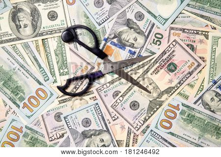Symbol of the sequester of the budget on the background of the American currency