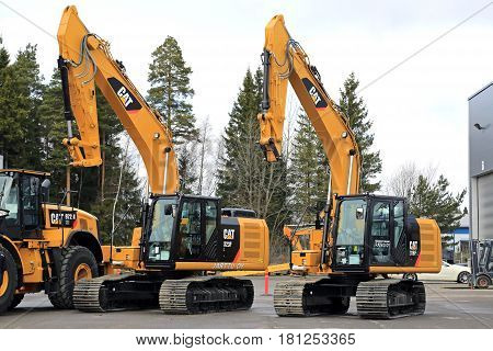 LIETO FINLAND - MARCH 25 2017: Cat 323FL and 316FL hydraulic excavators among Cat construction equipment seen at the annual public event of Konekaupan Villi Lansi Machinery Sales.
