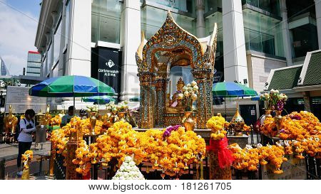 BANGKOK - MARCH 23: Buddhists worship the four-faced Brahma statue on March 23 2017 at Erawan Shrine in Bangkok. The Erawan Shrine is a Hindu shrine in Bangkok Thailand.