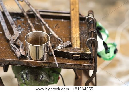 Metal fabricator utilizing a torch to heat up a piece of metal in order to shape it utilizing a forging technique developed over hundred years ago.