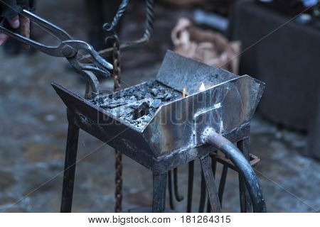 Metal fabricator utilizing a torch to heat up a piece of metal in order to shape it utilizing a forging technique developed over hundred years ago.