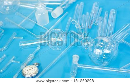 Laboratory glassware on blue color background with tubes