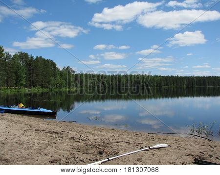 Kayak dry on the river bank after a hike.
