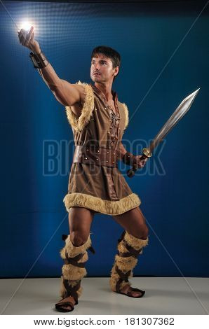 The handsome brute is holding up a light.