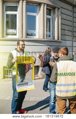 STRASBOURG FRANCE - APR 8 2017: Political agitation at French market for the upcoming French presidential election 2017 - man with My Voice hashtag mirror