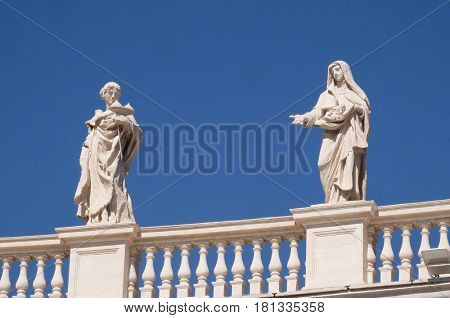 ROME, ITALY - SEPTEMBER 02: St. Agatha and St. Elizabeth of Portugal, colonnade of St. Peters Basilica - the world largest church, is the center of Christianity in Rome, Italy on September 02, 2016.