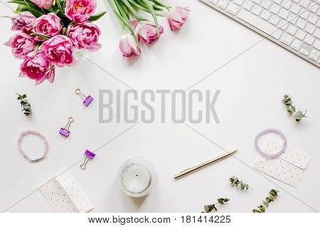 Woman office desk with spring flowers trend on white background top view mockup