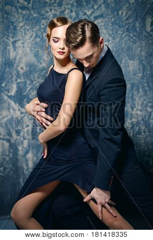 Beautiful passionate dancers dancing tango. Professional dancers. Couple in love dancing on a date. Love concept.