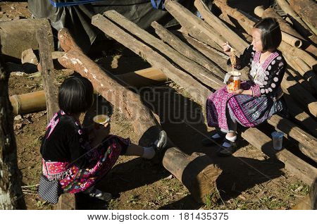 Children Girl Ethnic Hmong Wear Costume Traditional And Sitting Eat Breakfast With Friends At Doi Pu