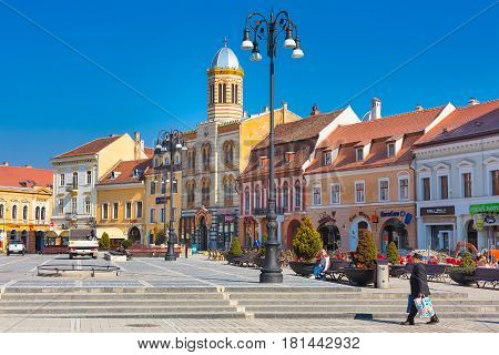 Brasov, Romania - March 24, 2015: The Orthodox Church of the Birth of the Mother of God at Council Square -Piata Sfatului - in downtown of Brasov and people near it