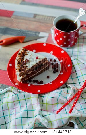 cake and tea in a pot polka dots on wooden background