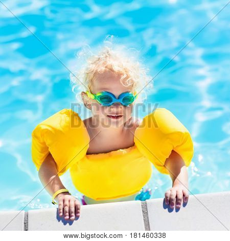 Little Baby Boy Playing In Swimming Pool