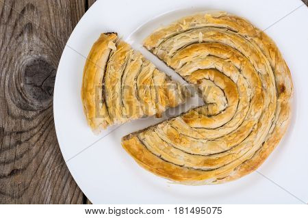Meat burekas from puff pastry on wooden background. Studio Photo