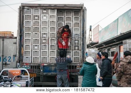 Beijing, China :21,Dec2014 -local people /seller packing goods from truck in A tranditional street market in Beijing China