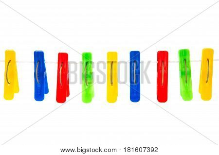 Some Colored Clothespins On A White Background