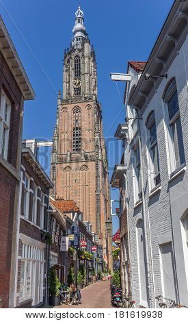 AMERSFOORT, NETHERLANDS - APRIL 09, 2017: Narrow old street and church tower in Amersfoort, Holland