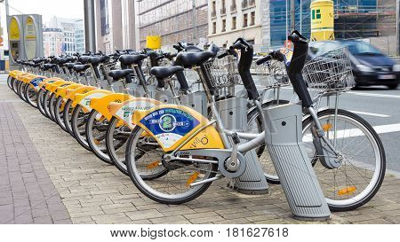 BRUSSELS BELGIUM - JULY 30 2014: Yellow bicycles of self-service Villo for rent in historical center of Brussels.