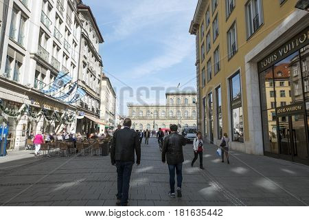 Munich-Bavaria-Germany. March 29 2017. View of Residenz street with people strolling and drinking beer on terraces. Near the Marienplatz.