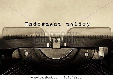 Endowment policy words typed on vintage typewriter.