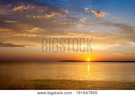 Beautiful colorful summer sea sunrise landscape with amazing colorful clouds in a blue sky in Crimea, Azov sea, Ukraine 2013.