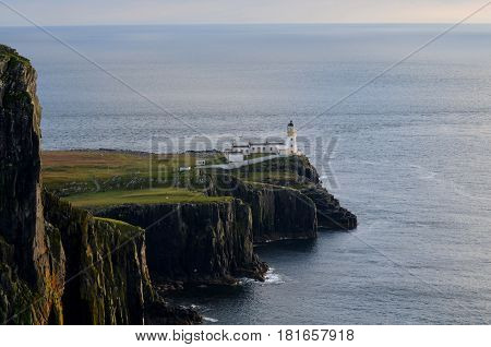Neist Point lighthouse and sea cliffs on Skye Scotland.