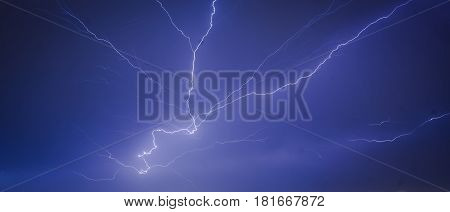 Lightning strikes in the city seen through the window, thunder in the night, thunderstruck over the cityscape