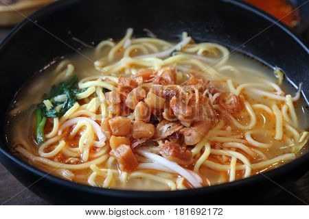 Chinese yellow noodle soaked in a prawn soup base as part of the famous Big Prawn Noodle dish unique in Singapore and Malaysia with toppings of pork lard