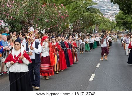 FUNCHAL PORTUGAL - SEPTEMBER 4 2016: Group of people in traditional costume durnig historical and ethnographic parade of Madeira Wine Festival in Funchal. Madeira Portugall