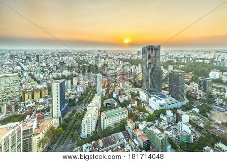 Ho Chi Minh City, Vietnam - April 11, 2017: High view Saigon skyline when the sun shines down urban areas with tall buildings along the road many trees show development country in Ho Chi Minh, Vietnam