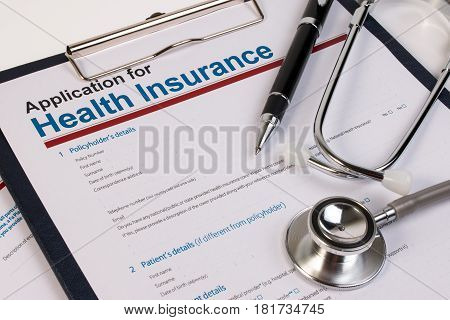 Application Form For Health Insurance, Paperwork, Questionnaire With Pen And Stethoscope. Health Ins