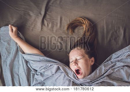 Beautiful Young Woman Lying Down In Bed And Sleeping, Top View. Do Not Get Enough Sleep Concept