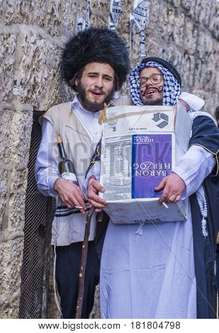 JERUSALEM - MARCH 13 : Ultra Orthodox men holding Mishloach Manot during Purim in Mea Shearim Jerusalem on March 13 2017 Mishloach Manot is traditional food gifts given during Purim
