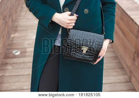 Cassic coat with leather handbag Stylish fashion model outdoor