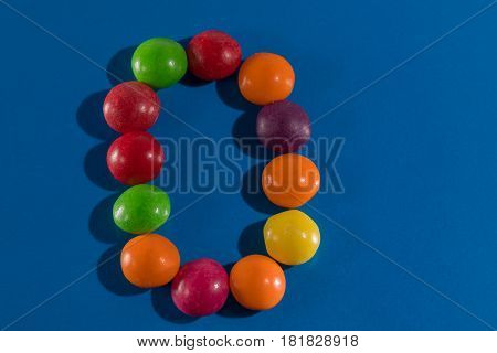Image of colorful and tasty candies skittles figue zero postcard