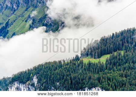 The Swiss Alps at Murren, Switzerland. Jungfrau Region. Tops of the mountains in fog and clouds.