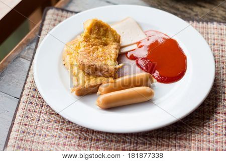 A typical American hearty breakfast with sausage ham Omelette and catchup