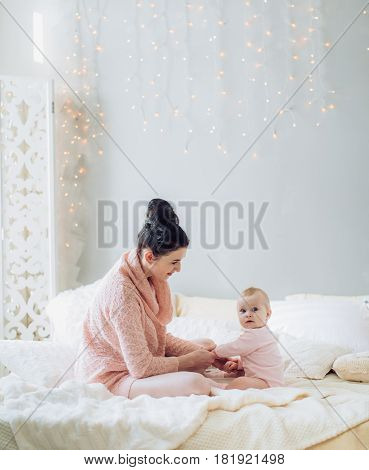 Young happy and beautiful mother with baby