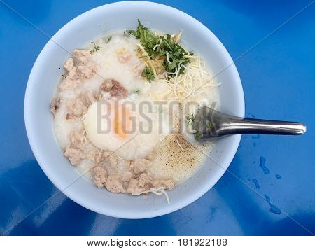 Traditional Thai Porridge Rice Gruel In White Bowl, Congee. In The Street Night Market.
