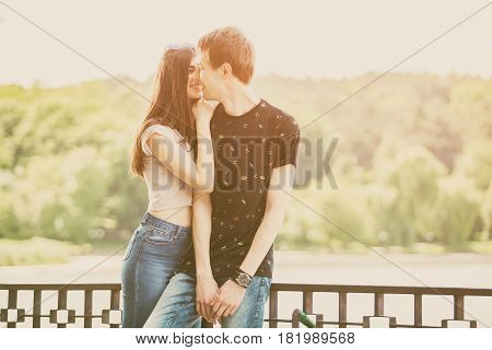 Caucasian couple taking a walk in the park. Lifestyle and relationship. Young inlove boyfriend and girlfriend