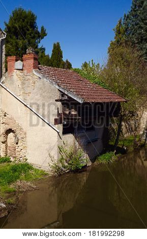 Ancient riverside house in La Chatre, central France