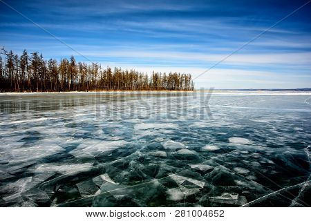 Frozen Lake Khubsugul. Beautiful Forest Near The Ice Surface On A Frosty Day. Natural Background