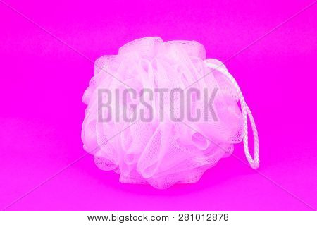 Pink Plastic Body Scrubber On Purple Paper Background.a Kind Of Medical Device For Cleaning The Body