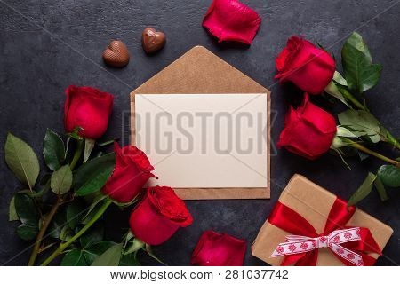 Red Rose Flowers Bouquet, Envelope, Gift Box, Chocolate Sweets On Black Stone Background Valentine's